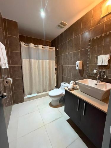a bathroom with a toilet and a sink at Villas del Mar PTY in Río Hato
