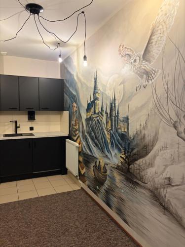 a kitchen with a castle mural on the wall at La Melodia in Kościerzyna