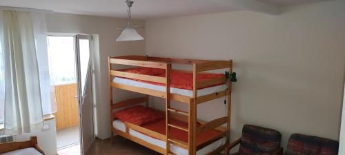 a room with three bunk beds in a room at Willa Madi in Grzybowo