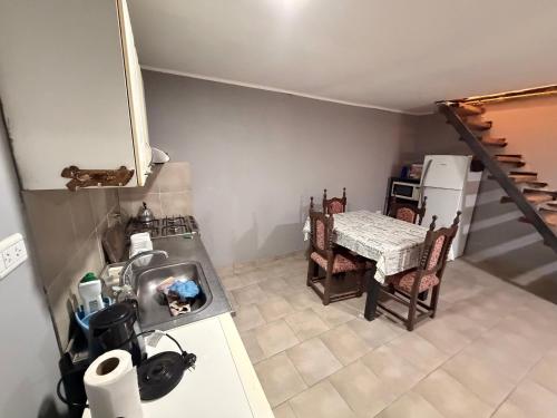 an overhead view of a kitchen with a table and refrigerator at Deptos Valen in Trevelín
