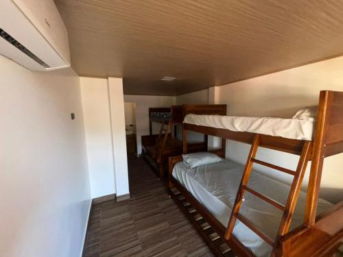 a room with three bunk beds in a room at Casa playera in Crucita