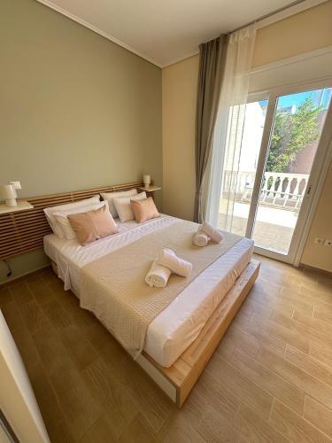 a bedroom with a large bed with towels on it at Apollonian House in Korinthos