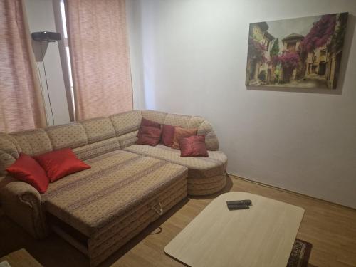 a living room with a couch and a table at Apartment nad Sveikem in Karlovy Vary
