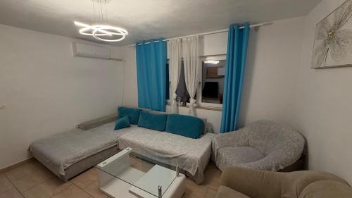 a living room with a couch and a chair at Modern Apartment in Arad