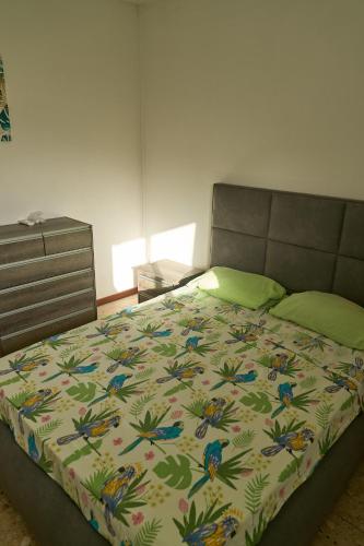 a bedroom with a bed with a colorful bedspread at Logement au vauclin in Le Vauclin
