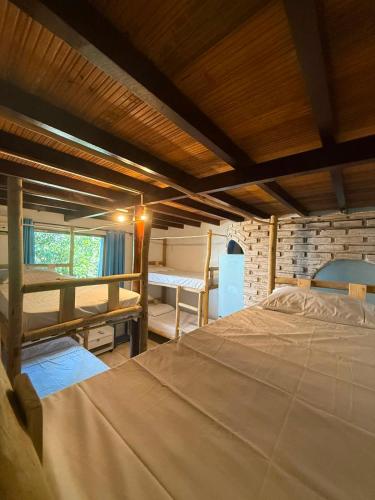 a bedroom with a large bed in a room at Arandú Hostel in Itacaré