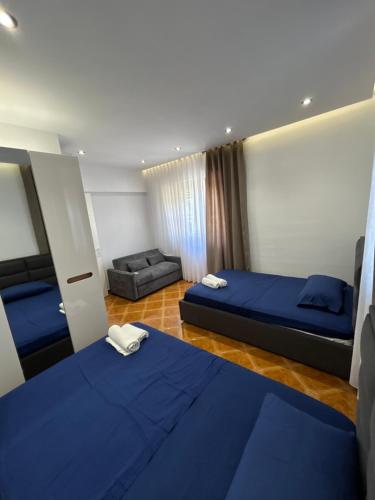 a hotel room with two beds and a couch at VillaSolmare Velipoje in Velipojë