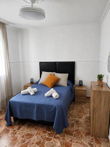 a bedroom with a bed with towels on it at Apartamento EL LUCENTINO in Lucena