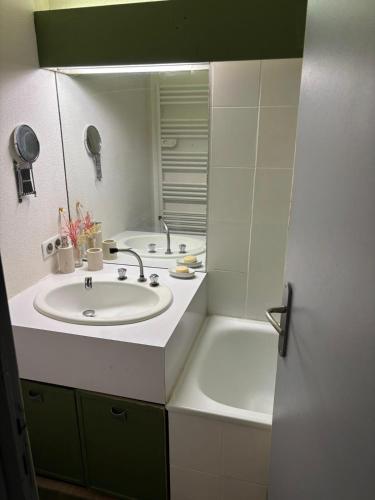 a bathroom with a sink and a mirror at Panorama à La Mongie in La Mongie