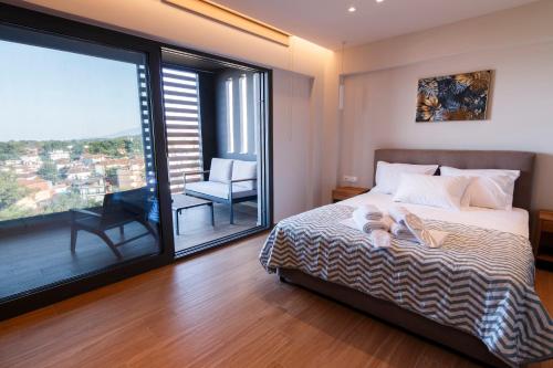 a bedroom with a bed and a large window at CASA UNO Horizon in Platamonas