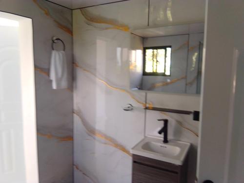 a bathroom with a sink and a mirror at Macao Sky pool Suite in Punta Cana