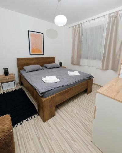 a bedroom with a bed with two towels on it at Kuća za odmor Na jezeru, Šoderica - Fenced Yard & Pet friendly holidayhouse in Legrad