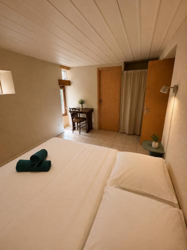 a large bed in a room with a table at Charmant T2 en RDC au centre de Figeac in Figeac