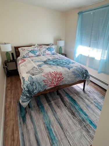 a bedroom with a bed and a window at Heavenly Properties SLM in Scituate