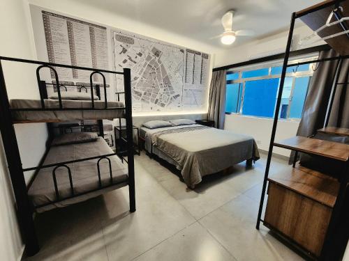 a bedroom with two bunk beds and a map on the wall at Ceci House - Santa Cecília in São Paulo