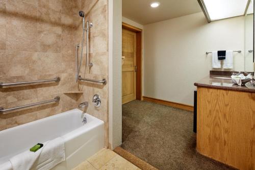 a bathroom with a tub and a sink at Cavalier Oceanfront Resort in San Simeon