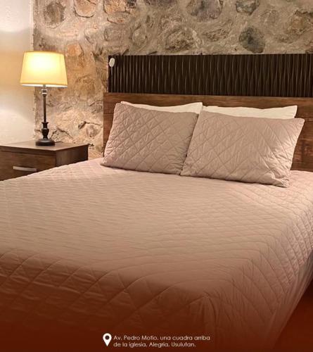 a bed with white sheets and pillows in a bedroom at Gran Bonanza Hotel in Alegría