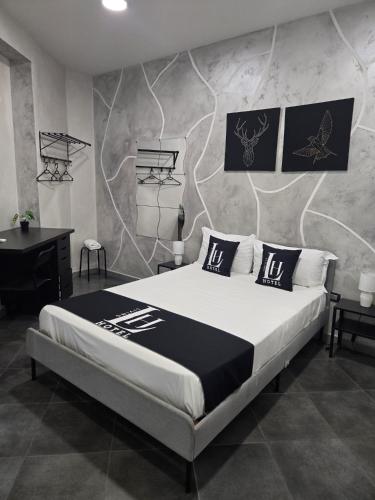 a bedroom with a large bed and a wall with a wall mural at Hotel Living in Casoria