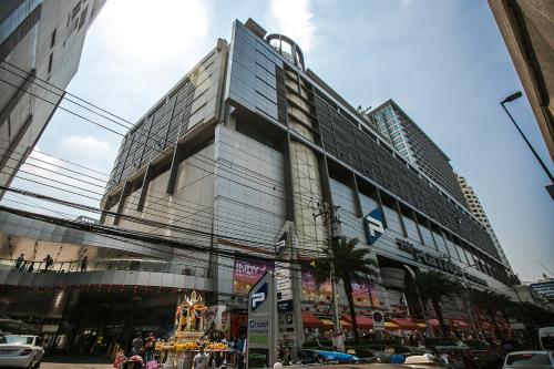 a tall building with a lot of windows on a street at Marwin Space in Bangkok