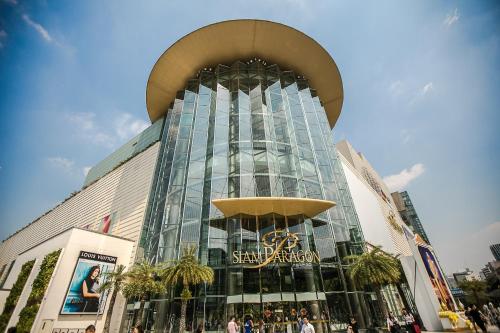 a large glass building with people standing in front of it at Marwin Space in Bangkok