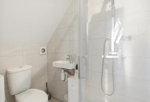a bathroom with a shower and a toilet and a sink at Sky View En-Suite in Egham