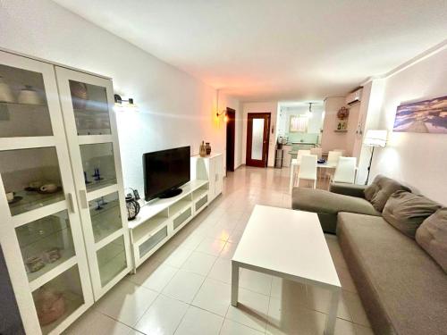 a living room with a couch and a table at APARTBEACH NARGAM Vista Playa in La Pineda