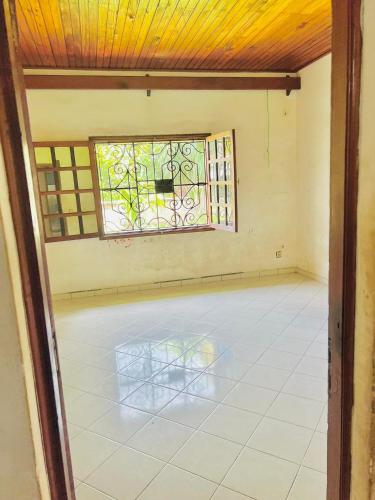 an empty room with a window and a chair at Villa Rapide in Ambanja