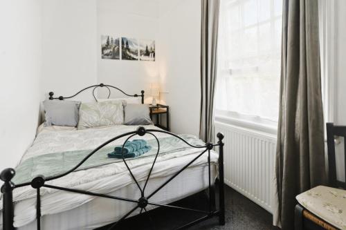 a bedroom with a bed and a window at Park View En-Suite in Egham