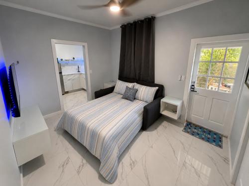 a bedroom with a bed and a window and a door at View Private Suite near LEGOLAND, Downtown & Hospital in Winter Haven