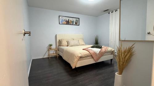 a bedroom with a bed in a white room at Velora Stays in Kelowna