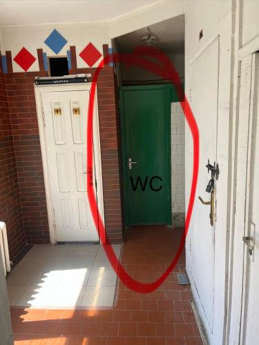 a red circle around a green door in a hallway at Budget Room Vilnius in Vilnius