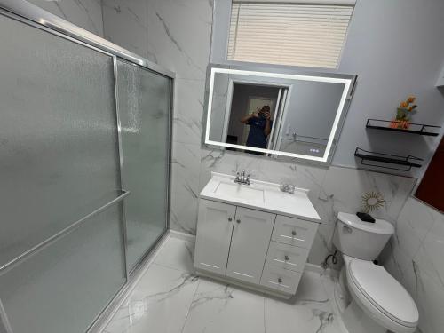 a woman taking a picture of a bathroom at View Private Suite near LEGOLAND, Downtown & Hospital in Winter Haven