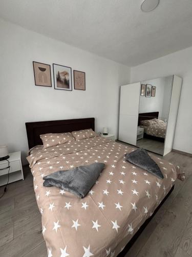 a bedroom with a large bed with white stars on it at Visitor Apartment-Plav in Plav