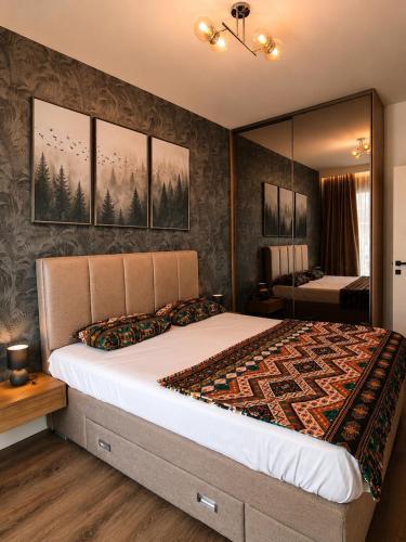 a bedroom with a large bed and a mirror at Becici residance pool and sauna in Bečići