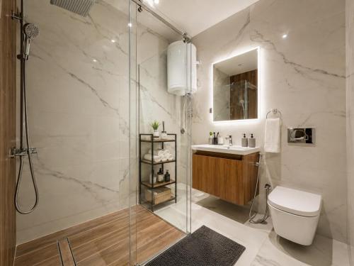 a bathroom with a shower and a toilet and a sink at Becici residance pool and sauna in Bečići