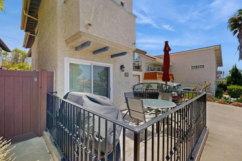 a balcony of a house with a table and a fence at San Clemente - Villa Del Mar in San Clemente