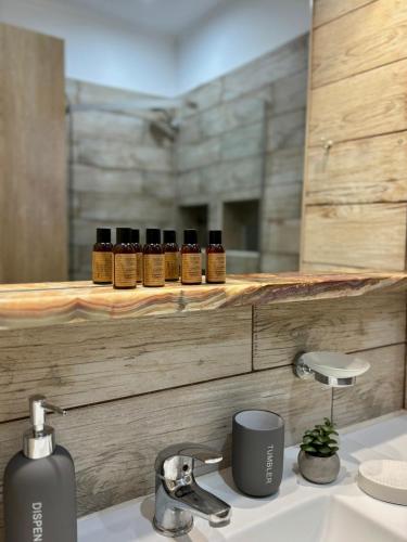 a bathroom with a sink and a counter with a mirror at Green House Skiathos in Skiathos