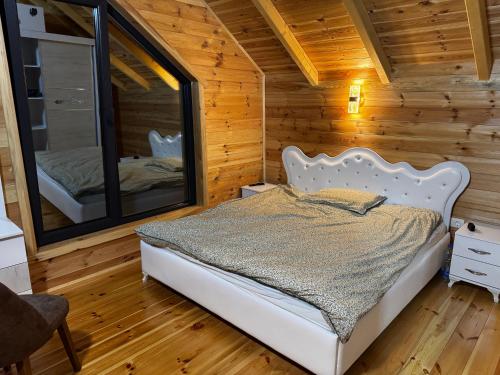 a bedroom with a bed and a large mirror at Agro Arge in Rožaje
