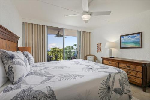 a bedroom with a bed and a ceiling fan at Puako Beach 309 Oceanview 3BR Condo in Waikoloa