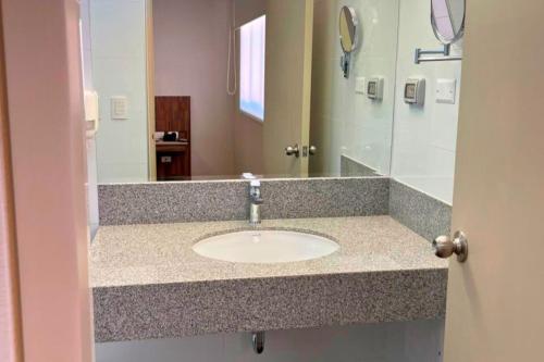a bathroom with a sink and a mirror at DM Hoteles Ayacucho in Ayacucho