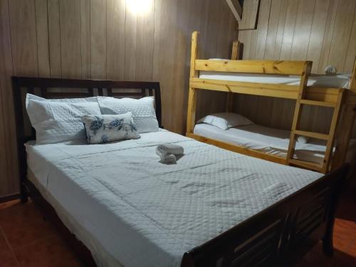 a bedroom with a bed and a bunk bed at 2 Pools - Solar - Playa Santa - Apto E in Guanica