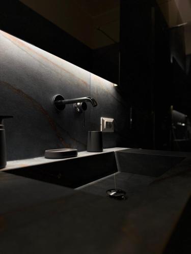 a bathroom with a sink and a faucet at Catalano Suite Marina - Vista Mare in Palermo