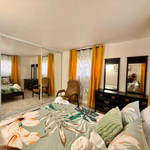 a bedroom with a bed and a large mirror at Spacious 2BR Apt - Kitchen - Laundry - WiFi in Yauco