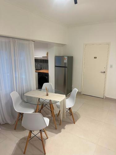a table and chairs in a room with a kitchen at Colón 2 in Mar del Plata