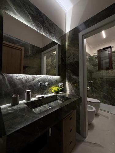 a bathroom with a sink and a toilet at Catalano Suite Giada - Vista Mare in Palermo