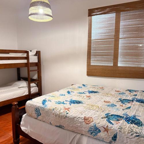a bedroom with a bed and a window at Walk to Beach - Pool - Billar - Apto D in Guanica