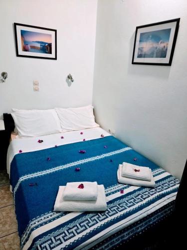 a bed with towels on it in a room at Rooms Mike Paros in Kampos Paros