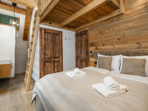 a bedroom with a large bed with towels on it at Chalet Paul in Katschberghöhe