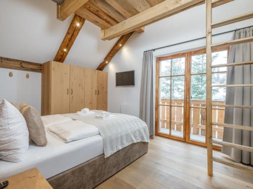 a bedroom with a bed and a large window at Paul und Petra in Katschberghöhe