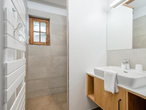 a bathroom with a sink and a mirror at Chalet Cornelia in Gatschberg